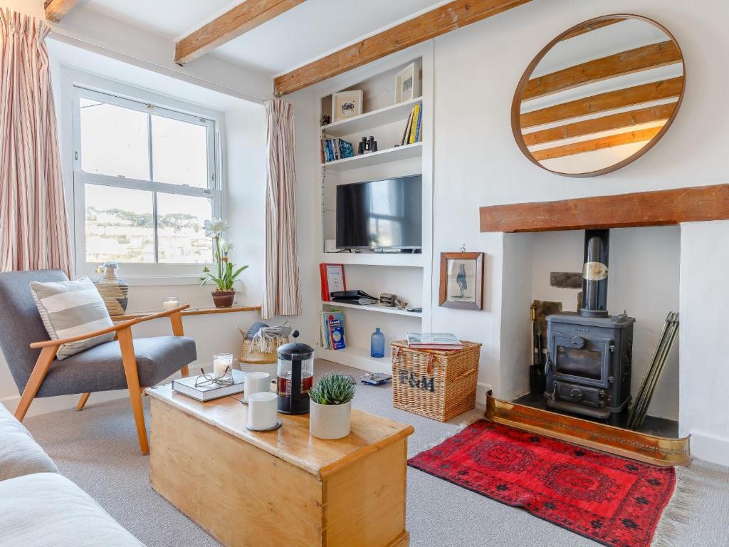a living room with a couch and a fireplace at 3 Bed in Polruan PC009 in Fowey
