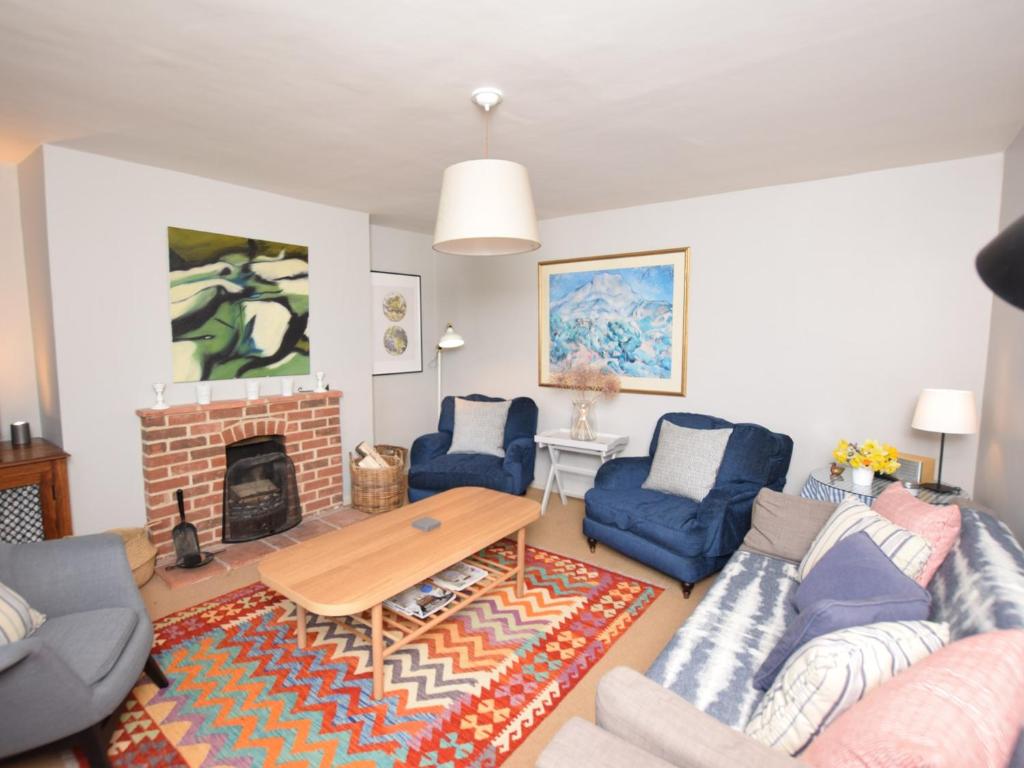 a living room with a couch and a fireplace at 3 Bed in Kettlestone KT037 in Little Snoring