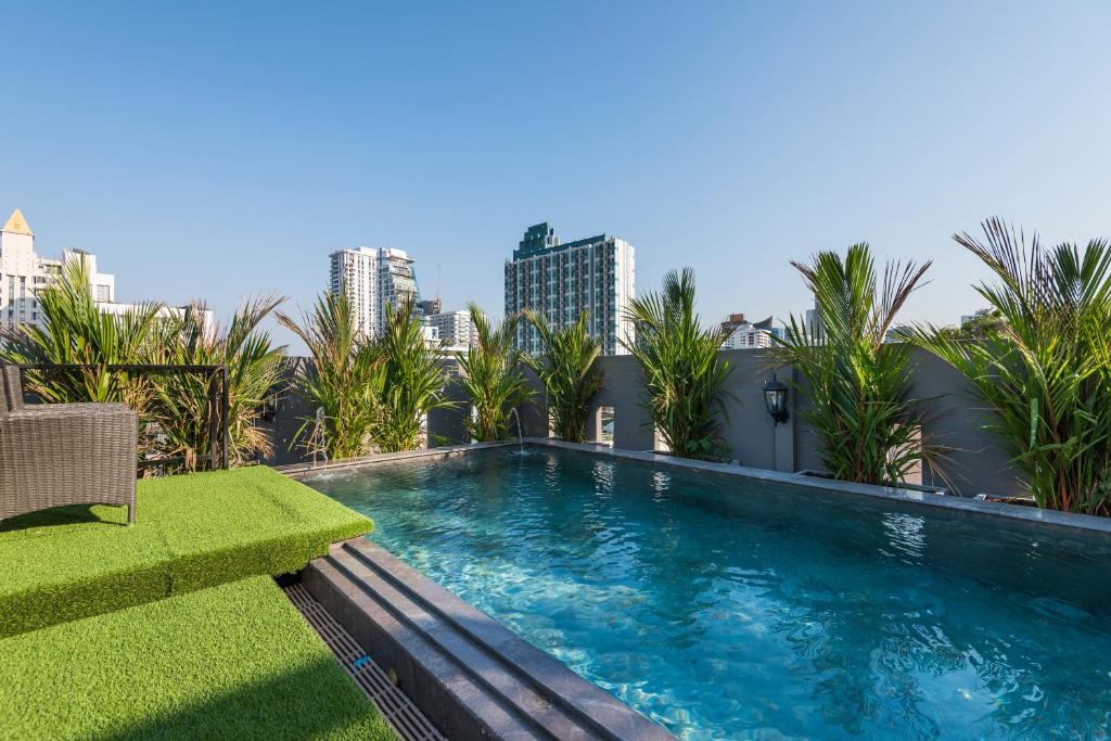 a swimming pool on the roof of a building at The Elite @ Thong Lor 25 in Bangkok