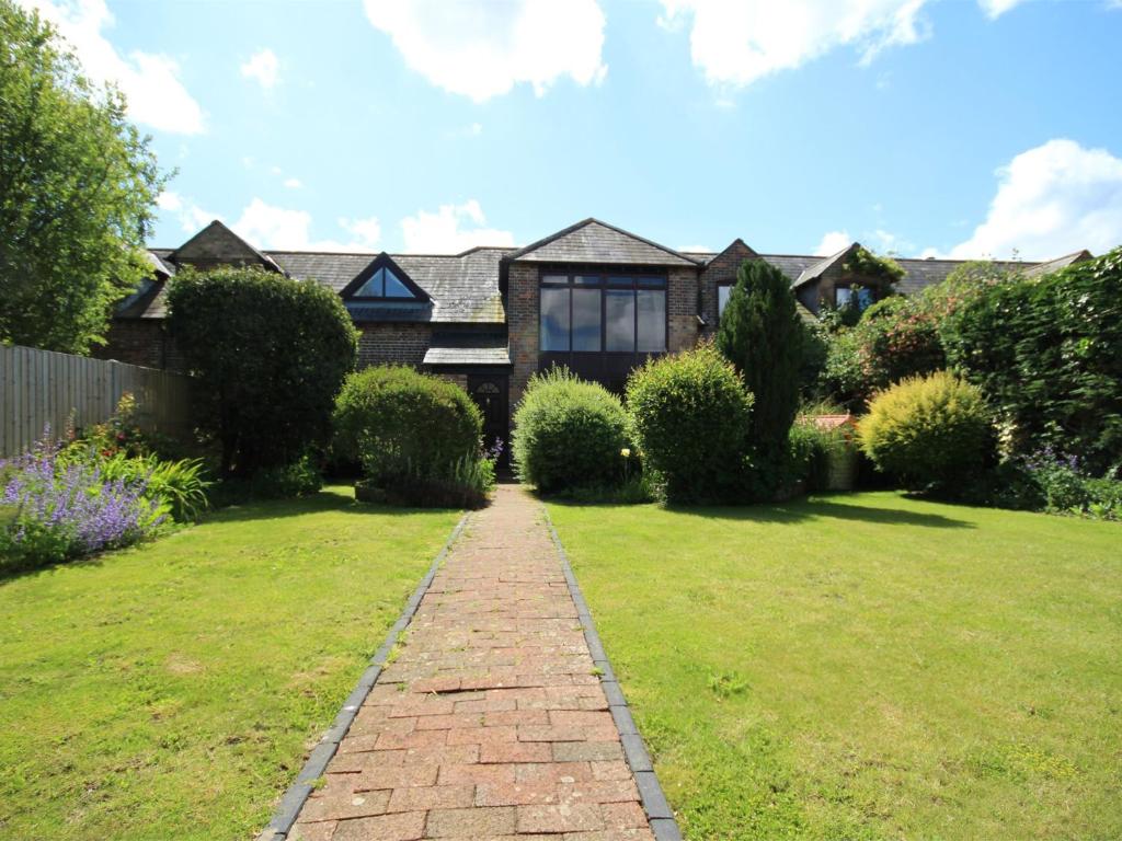 a house with a brick pathway in front of a yard at 3 Bed in East Stoke DC106 in East Stoke