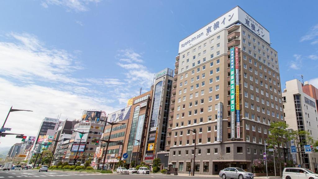 a tall building on a city street with cars at Toyoko Inn Hokkaido Sapporo Susukino Kosaten in Sapporo