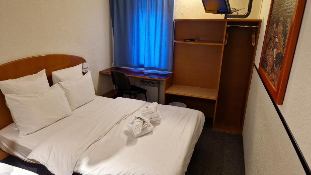Postel nebo postele na pokoji v ubytování Quick Palace Epinal