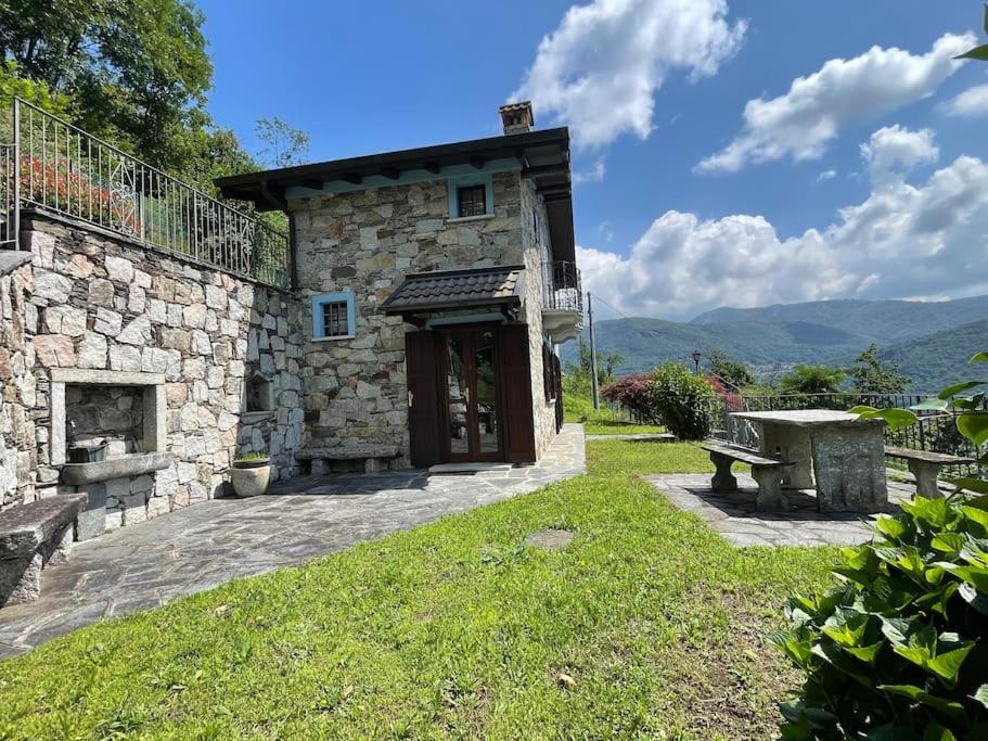 a stone building with a bench in front of it at Into the wild in Oira