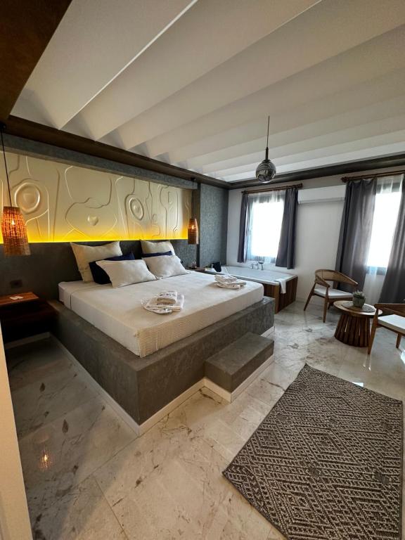 a bedroom with a large bed in a room at RÜYA BOHEME HOTEL BODRUM in Bodrum City