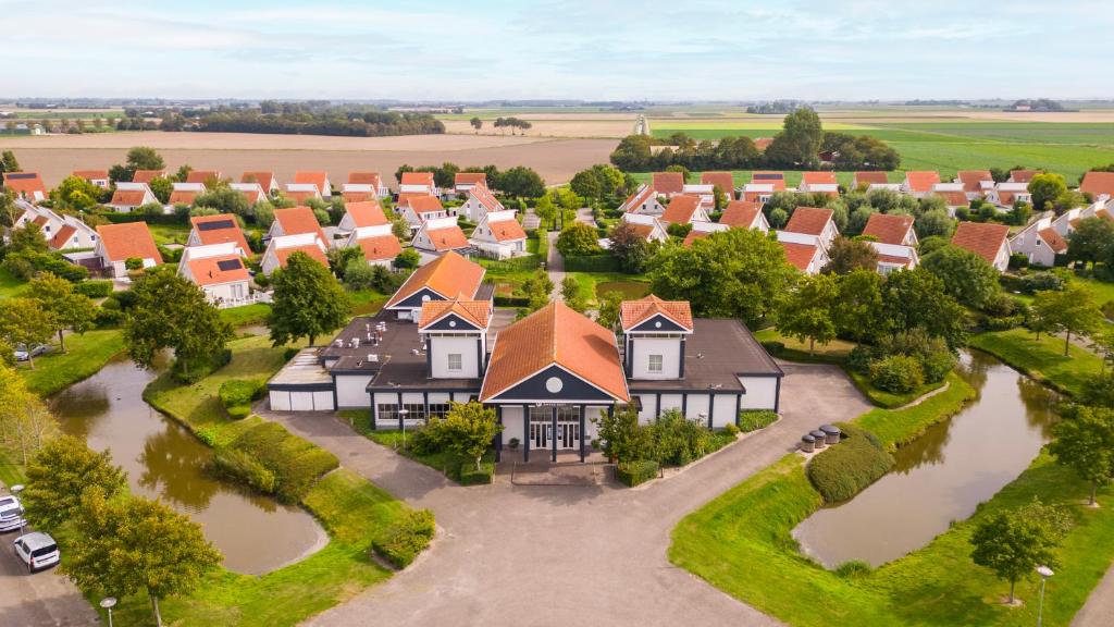 an aerial view of a village with houses at Summio Zeeland Village in Scharendijke