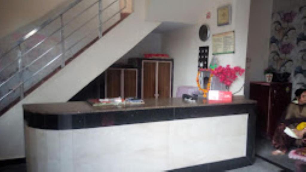 a kitchen with a counter and a staircase at HOTEL TAJ DELUXE, Agra in Agra