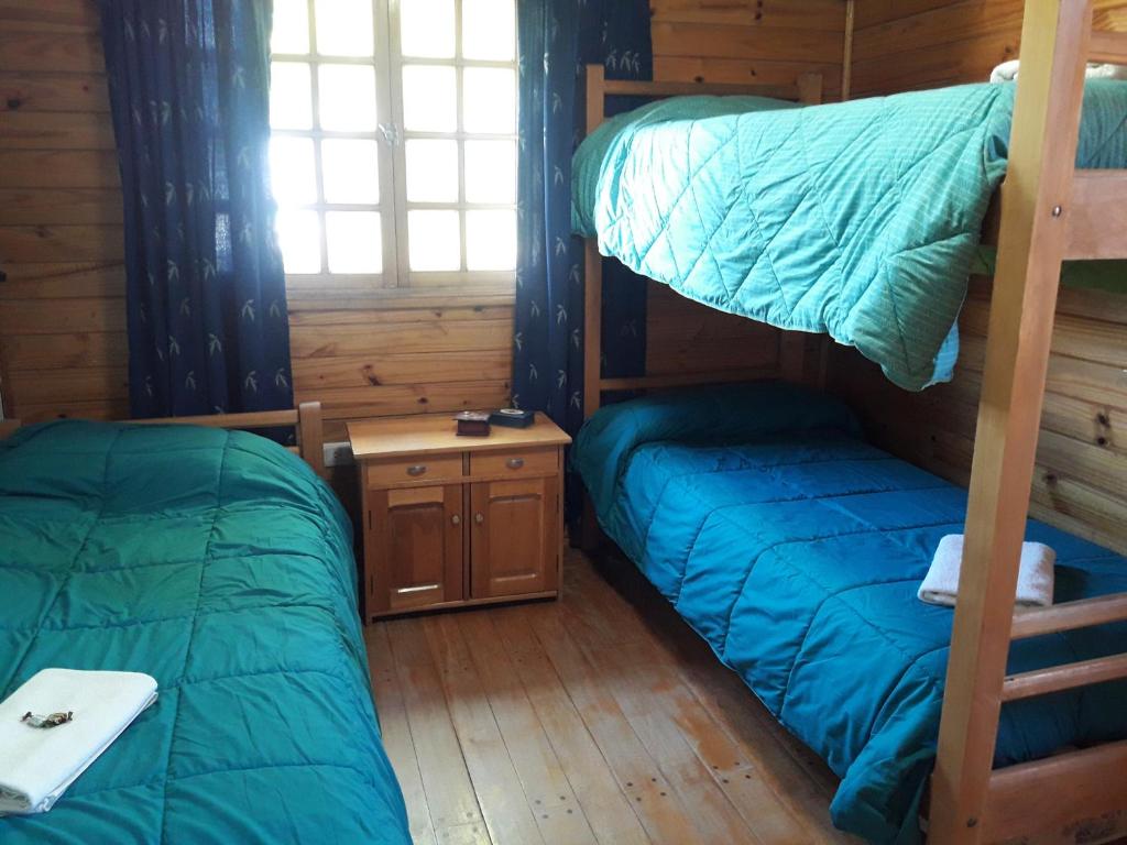 מיטה או מיטות בחדר ב-Pucon Antu