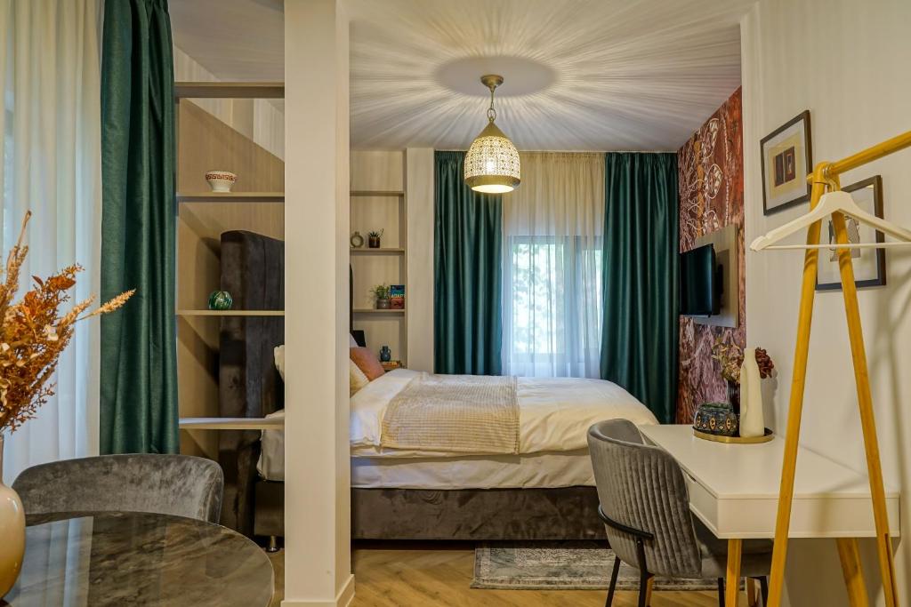 a bedroom with a bed and a desk and a table at The Miracle in Bucharest
