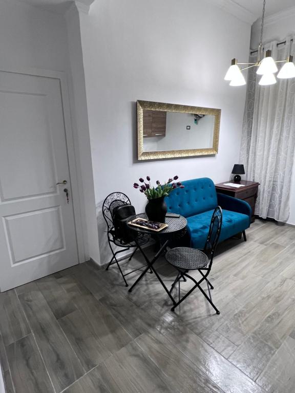 a living room with a blue couch and a table at Guest House Biondi Cavour in Rome