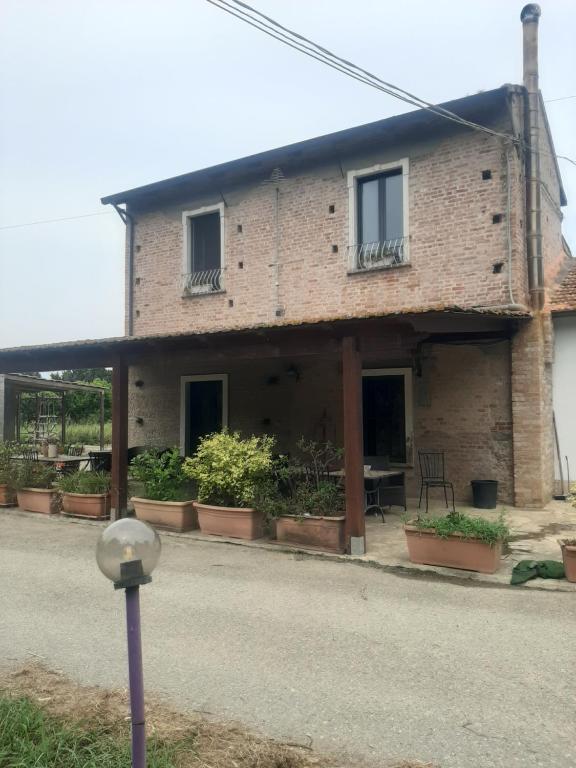 ceglany dom z doniczkami przed nim w obiekcie Casale Neocastrum w mieście Lamezia Terme