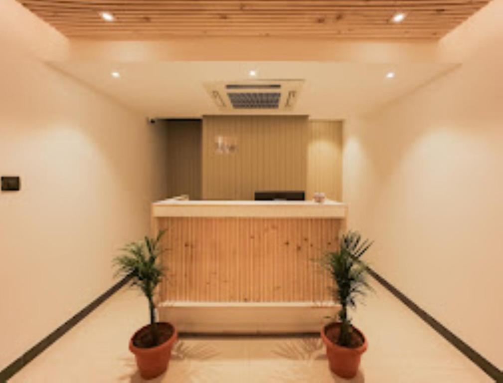 an office with two potted plants in a room at MAX PRIME, Madurai in Madurai