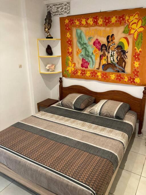 Postel nebo postele na pokoji v ubytování APPARTEMENT COSY TERRASSE VUE MER - TROIS ÎLETS