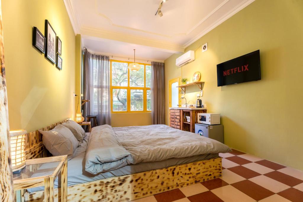 a bedroom with a bed and a checkered floor at 1- Homestay Hanoi- Cozy - Street view - Perfect Location in Hanoi