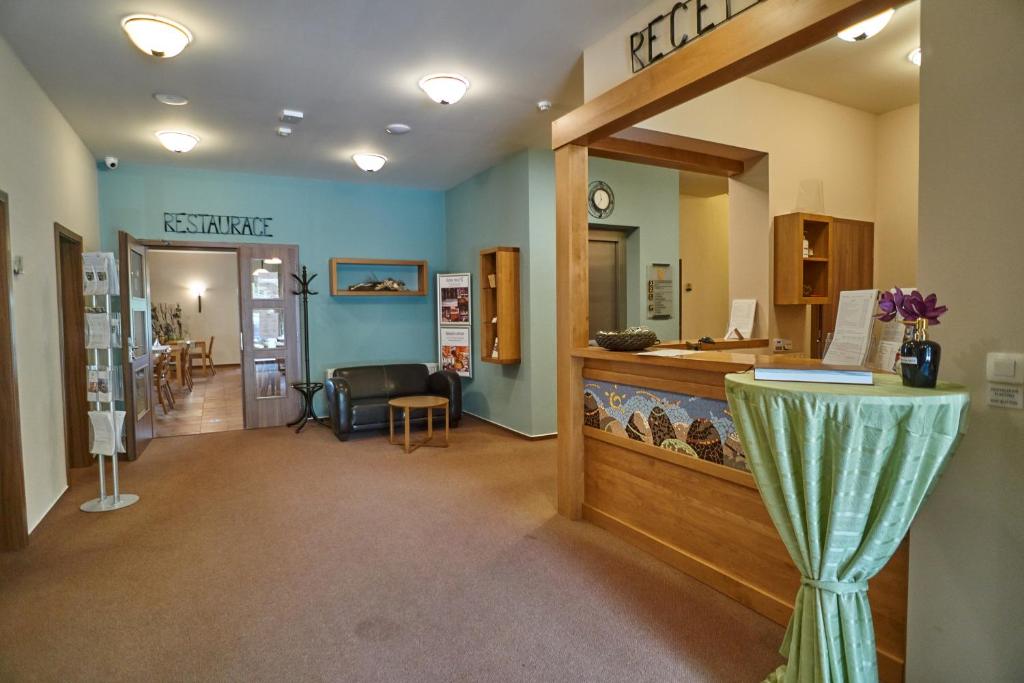 a waiting room with a counter in a pharmacy at Hotel Toč in Lipova Lazne