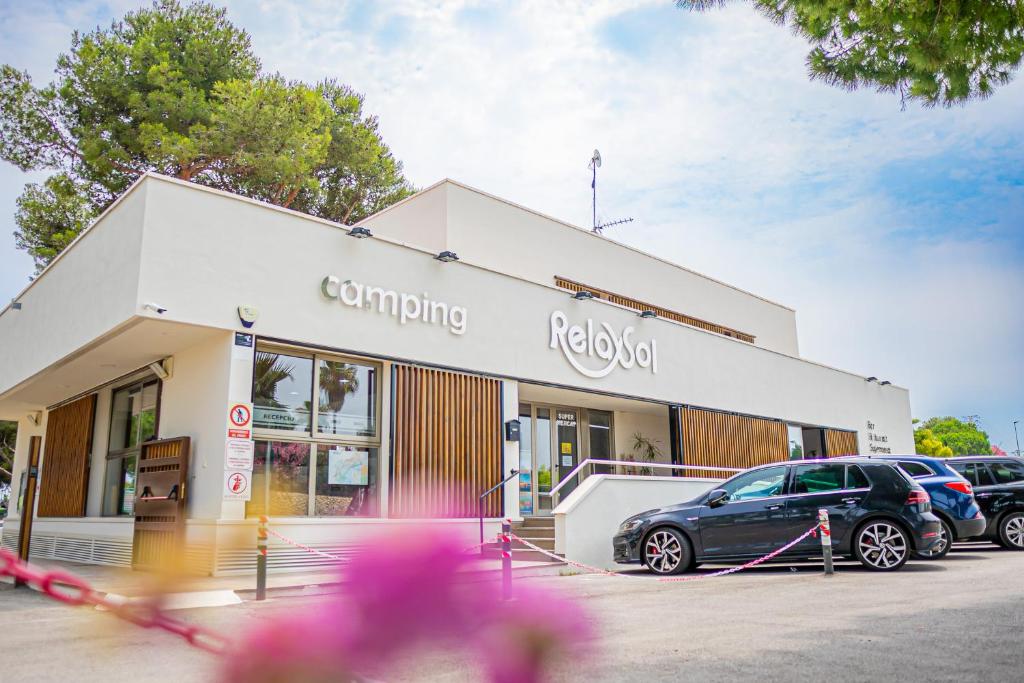 a car parked in front of a car dealership at Camping Relax Sol in Torredembarra