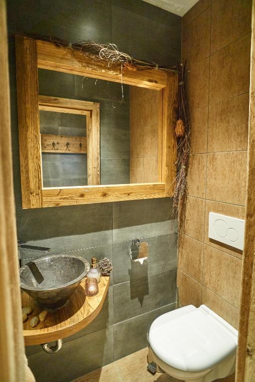 a bathroom with a sink and a toilet at Hotel Toč in Lipova Lazne