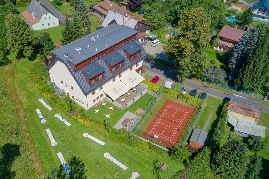 an aerial view of a large house with a tennis court at Hotel Toč in Lipova Lazne