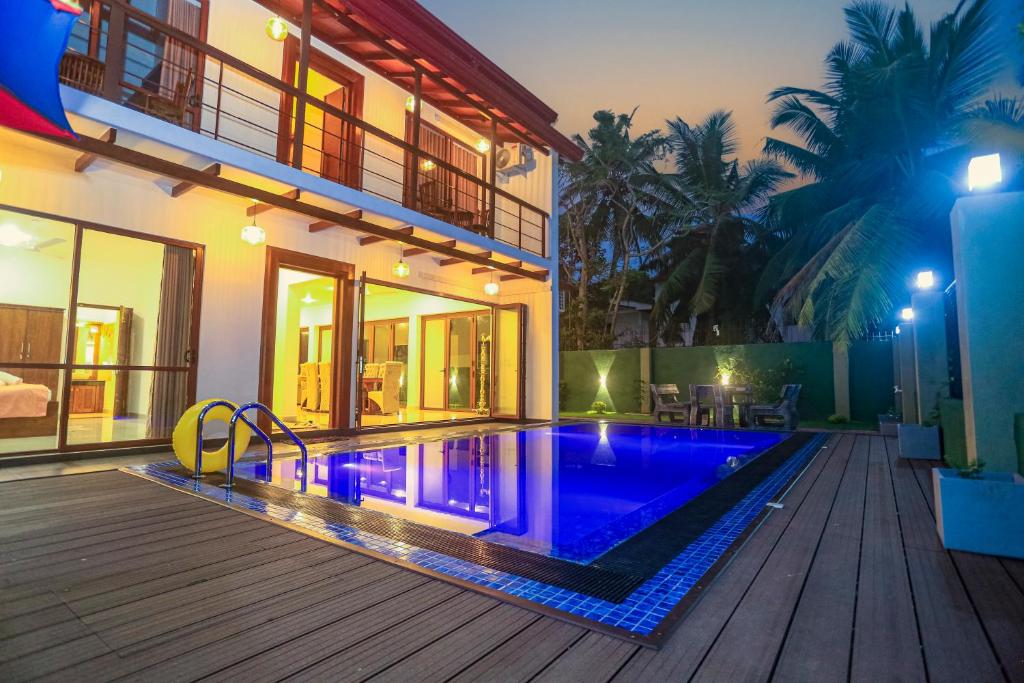 a swimming pool in the backyard of a house at Villa Senaya in Galle