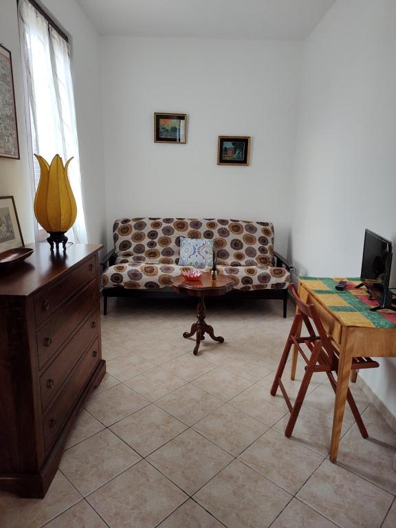 a living room with a couch and a table at I tetti di Pavia in Pavia