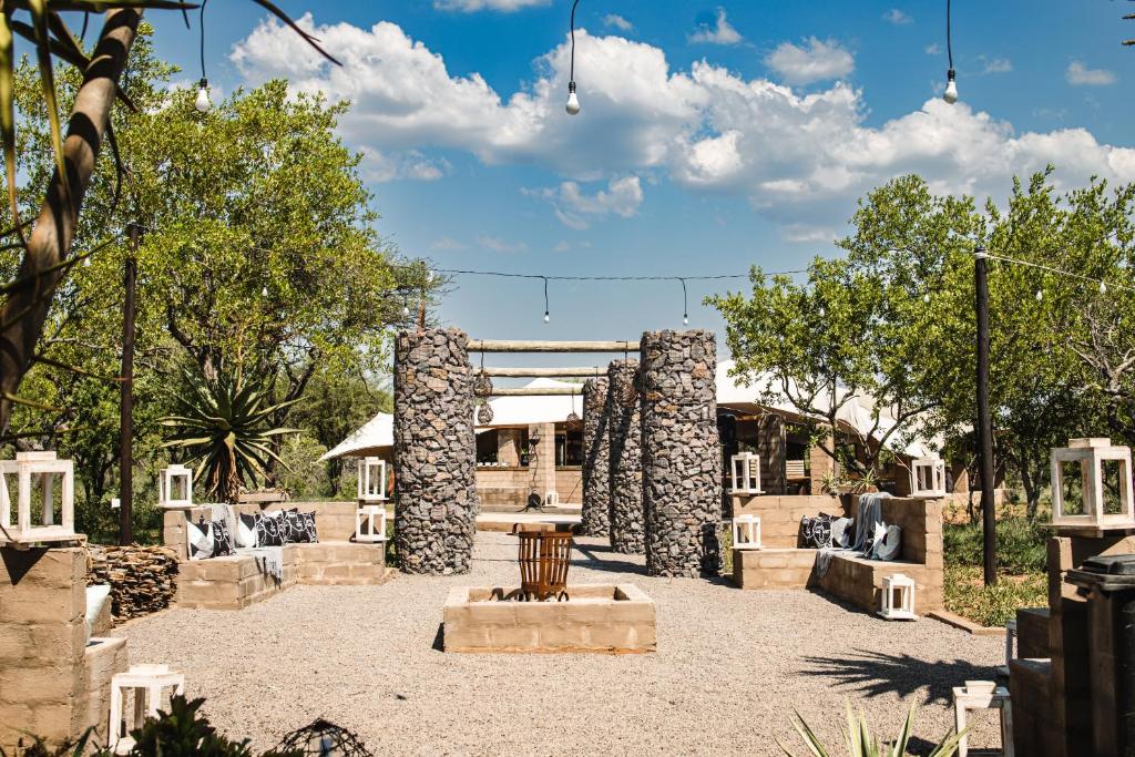 a building with stone pillars in a courtyard at Buffalo Ranch Game Lodge in Groblersdal