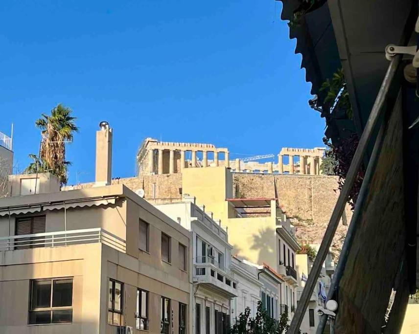a view of the ruins of a city with buildings at Spacious 2BDs Apt With Acropolis View In Center in Athens