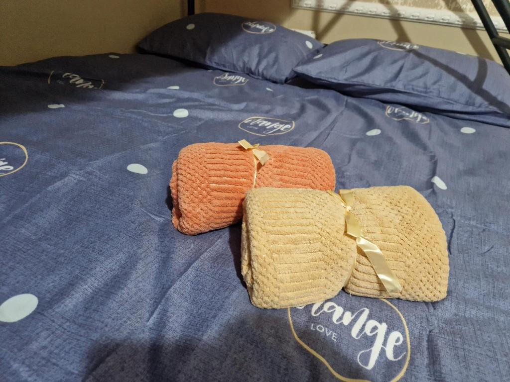 a pair of crocheted bags on top of a bed at Buddha Hostel in Chişinău