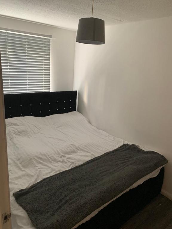 a bed with a black headboard in a bedroom at 1 bed fully furnished Walsall property in Walsall