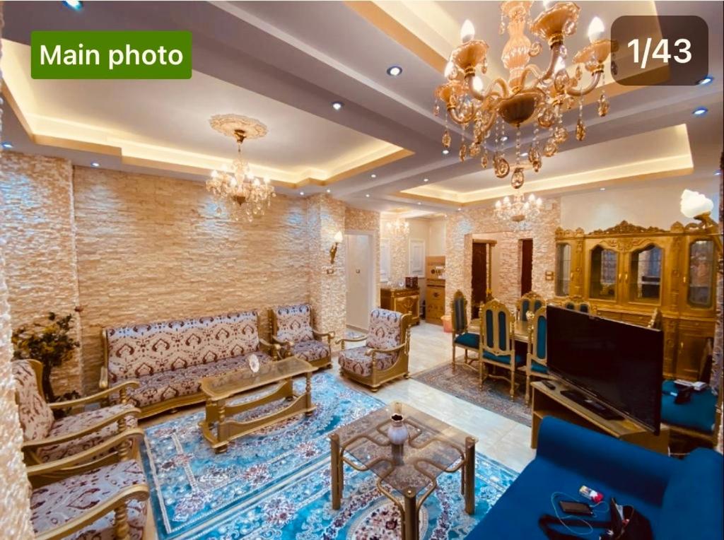 a large living room with a chandelier and a living room at LuXury Apartment Agouza-Mohandesin in Cairo