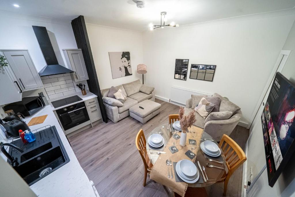 an overhead view of a living room with a table and chairs at Charming 1-Bedroom Just 1 Mile from Morley Town Center in Leeds in Pudsey