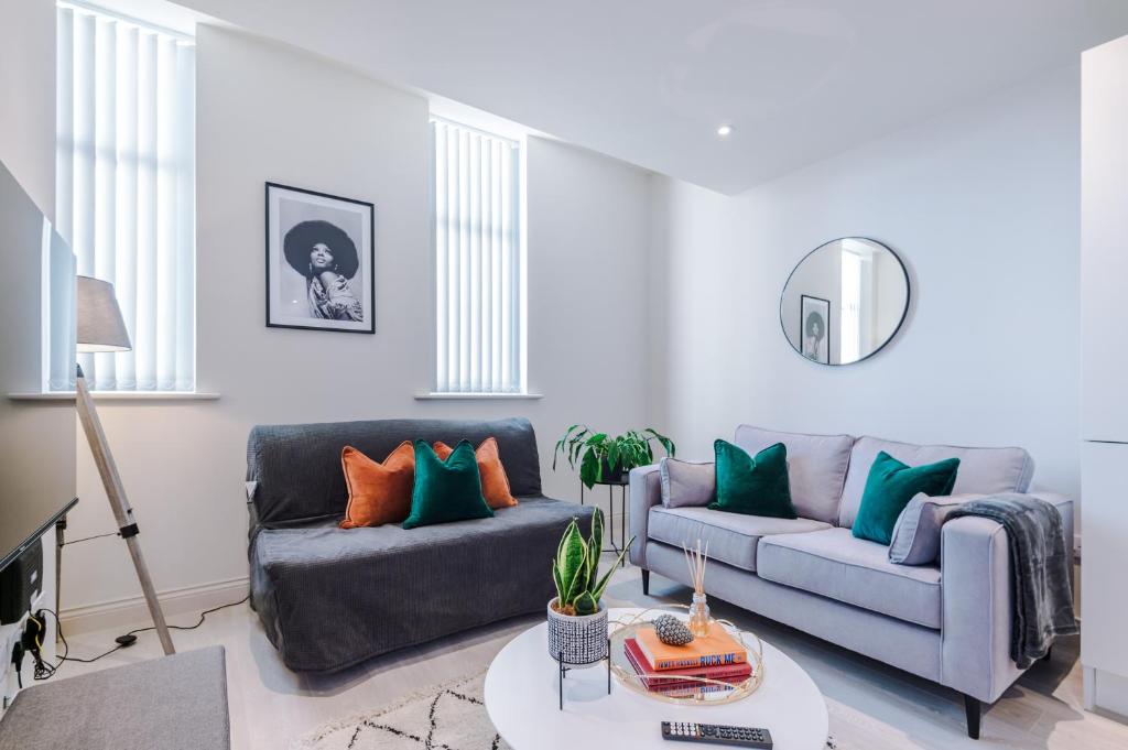 a living room with two couches and a table at Modern Flat in Leeds by PureStay Short Stays in Leeds
