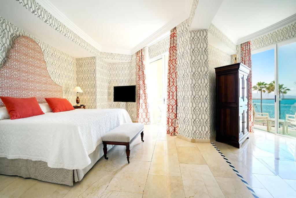 a bedroom with a bed and a large window at Bull Reina Isabel & SPA in Las Palmas de Gran Canaria