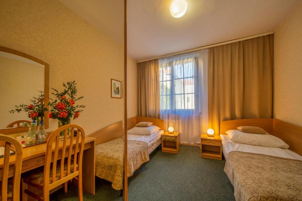 Postel nebo postele na pokoji v ubytování Hotel Gromada Toruń