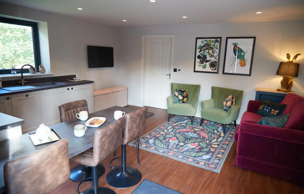 a kitchen and living room with a table and a couch at Cumbria Holiday Apartment Ainstable in Ainstable