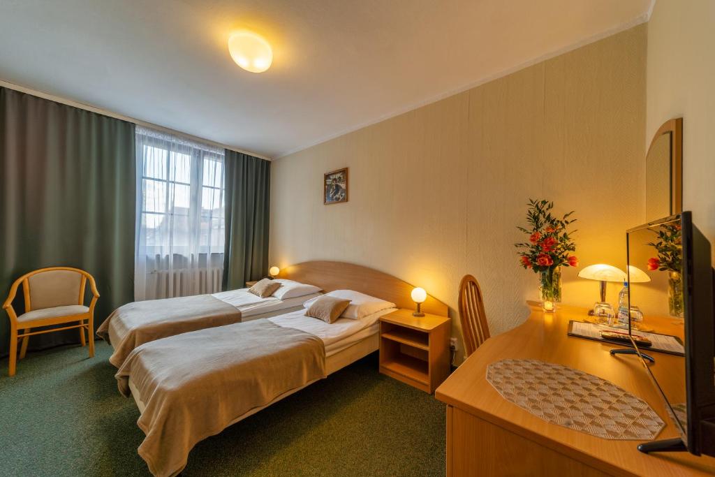Postel nebo postele na pokoji v ubytování Hotel Gromada Toruń