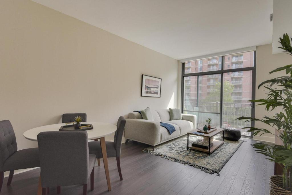 a living room with a couch and a table at Bethesda 1br w gym concierge nr metro station WDC-807 in Bethesda
