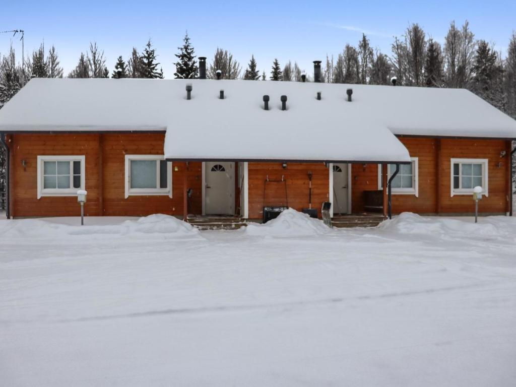 a house covered in snow with a lot of snow at Holiday Home Lampitaival 6a by Interhome in Kotila