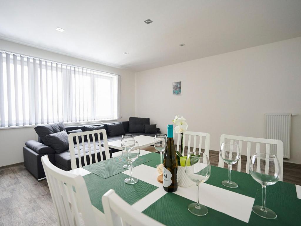 a living room with a table with wine glasses at Apartment U Dzina-3 by Interhome in Polubný