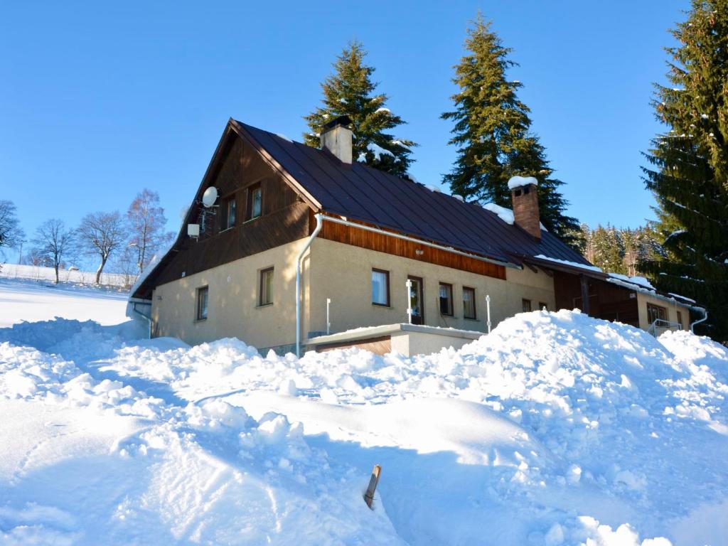 a house with a pile of snow in front of it at Holiday Home Hoja 2 by Interhome in Vítkovice