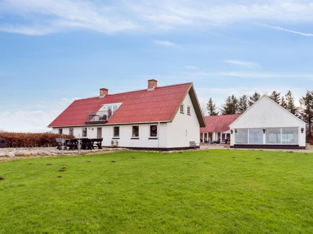 a white house with a red roof and a yard at Holiday Home Sune - 6km from the sea in NW Jutland by Interhome in Thisted