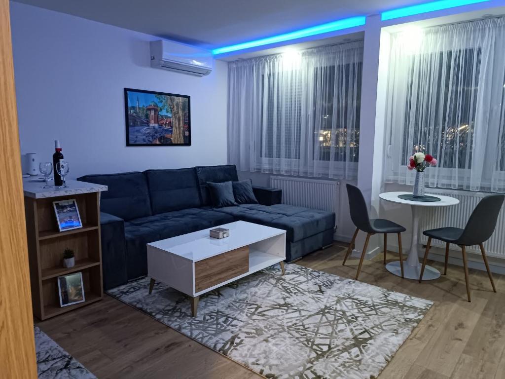 a living room with a couch and a table and chairs at Apartman ''Airplane'' Sarajevo in Sarajevo
