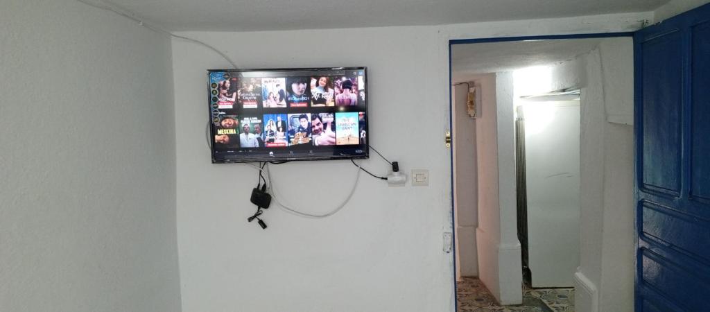 uma televisão de ecrã plano numa parede num quarto em Moulay Idriss em Moulay Idriss