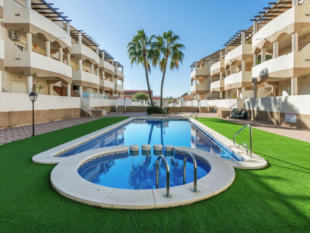 an empty swimming pool in front of a building at Apartment Om by Interhome in Vinaròs