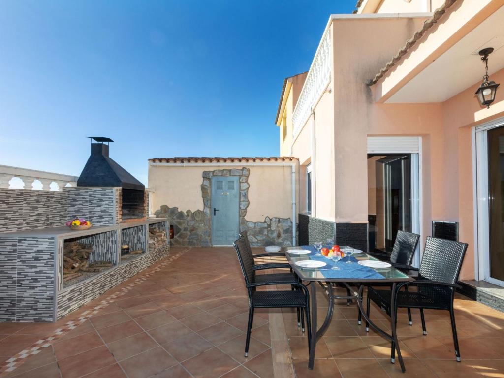 a patio with a table and chairs and a fireplace at Holiday Home Wunder Haus by Interhome in Vinarós