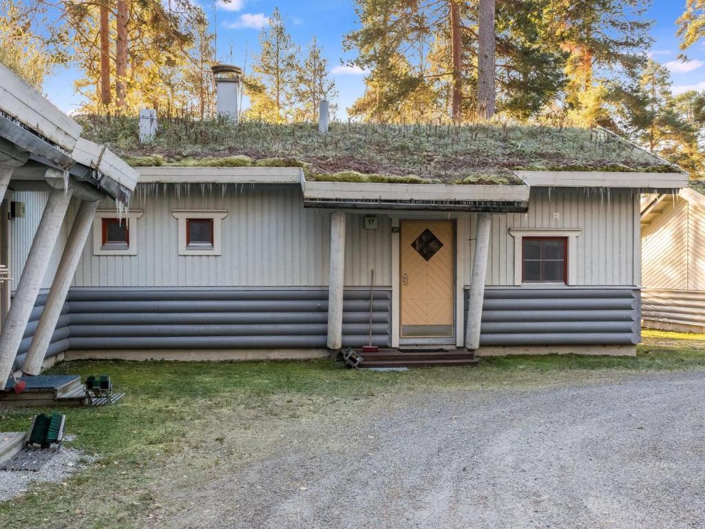 a house with a grass roof with a door at Holiday Home Kulta-käkönen 17 by bomba by Interhome in Nurmes