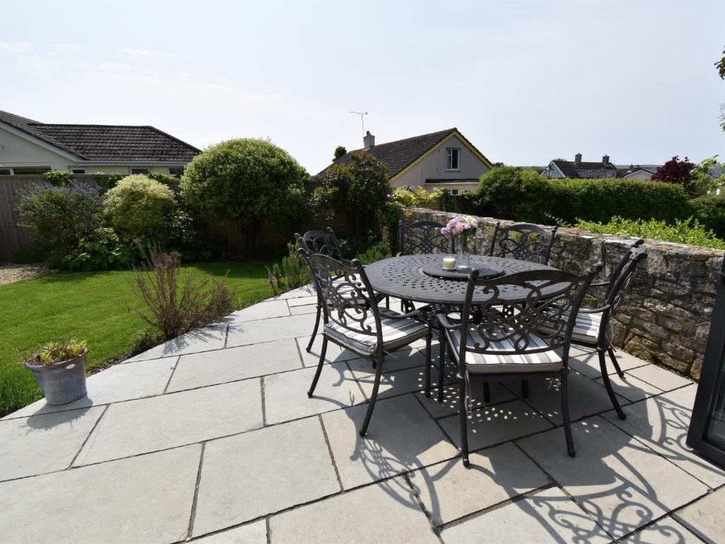 a table and chairs sitting on a patio at 3 Bed in Swanage 79405 in Swanage