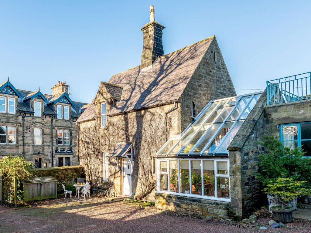 an old stone house with a glass roof at 2 Bed in Alnmouth 81280 in Alnmouth