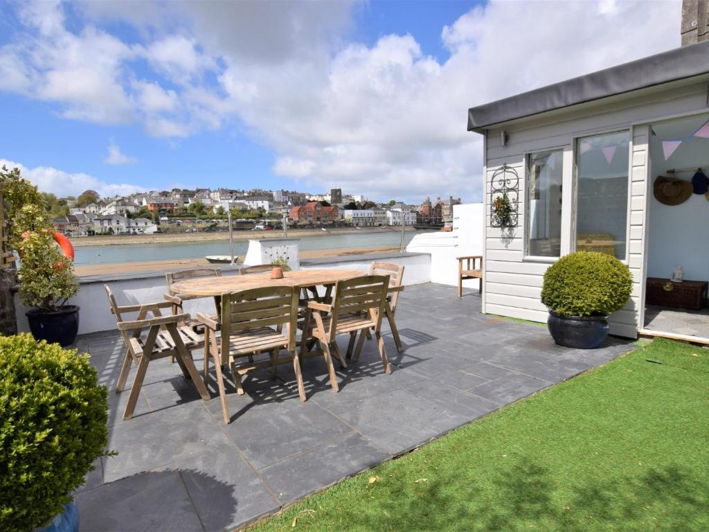 a patio with a table and chairs next to a house at 3 Bed in Bideford 79552 in Bideford
