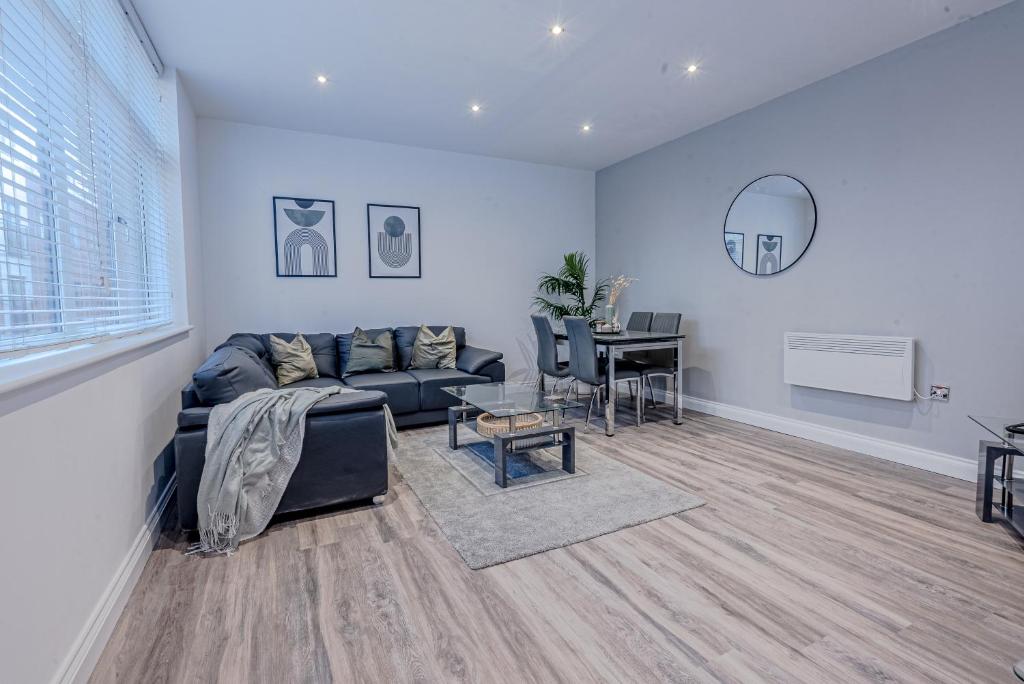 a living room with a couch and a table at Stunning Three Bedroom Townhouse In The Jewellery Quarter, Birmingham City Centre Sleeps 5- Free Parking in Birmingham