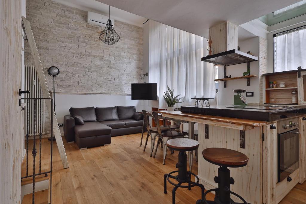 a kitchen and living room with a couch and a table at [Porta Genova] Navigli country house in Milan