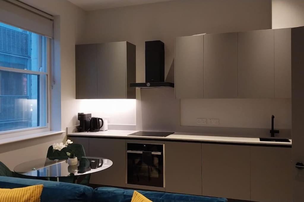 a kitchen with a couch and a table in a room at Soho super apartment in London